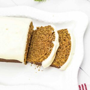 starbucks gingerbread loaf on white platter with two slices sliced