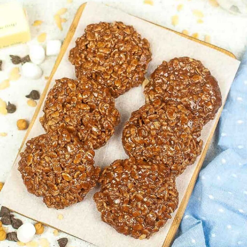 top view of 6 homemade star crunch cookies on a cutting board on parchment paper