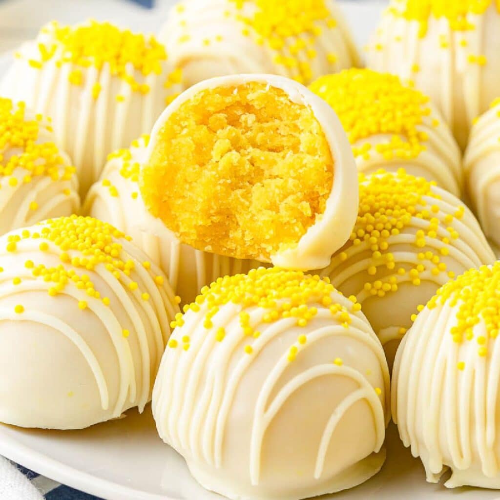 Front close up of Lemon Cake Balls with a bite taken from the top one.