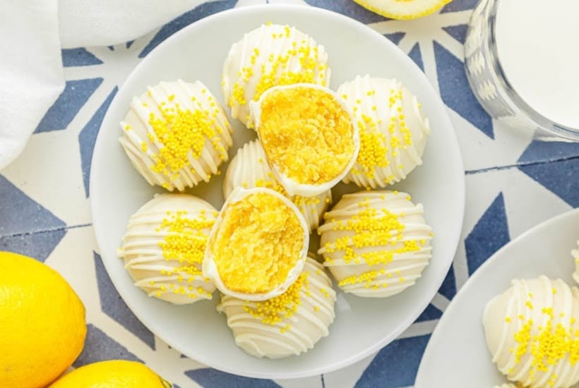 Overhead view of a plate of citrus cake bites, one split in half.