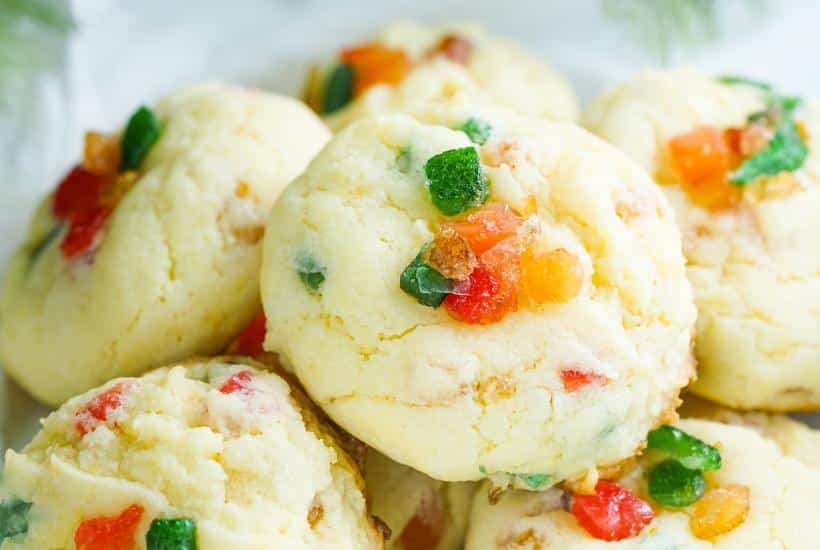 Closeup view of fruit cake cookies made with cake mix piled on a plate.