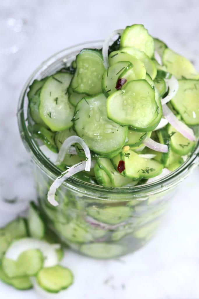 A jar of cucumber and onion salad.