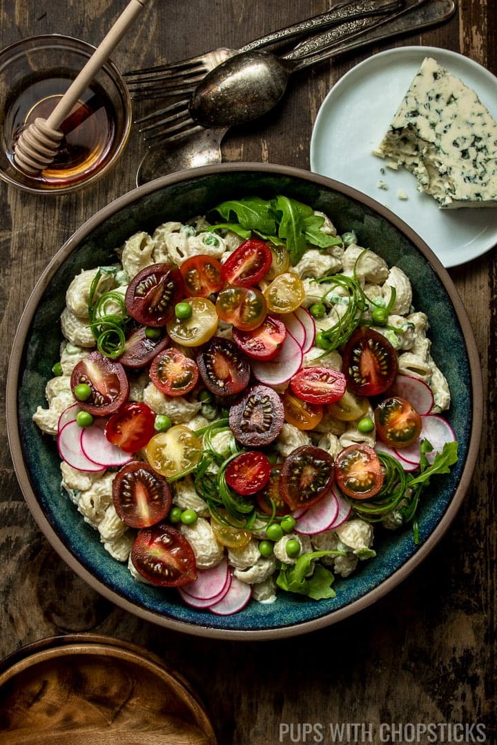 Pasta salad with tomatoes and tangy blue cheese.