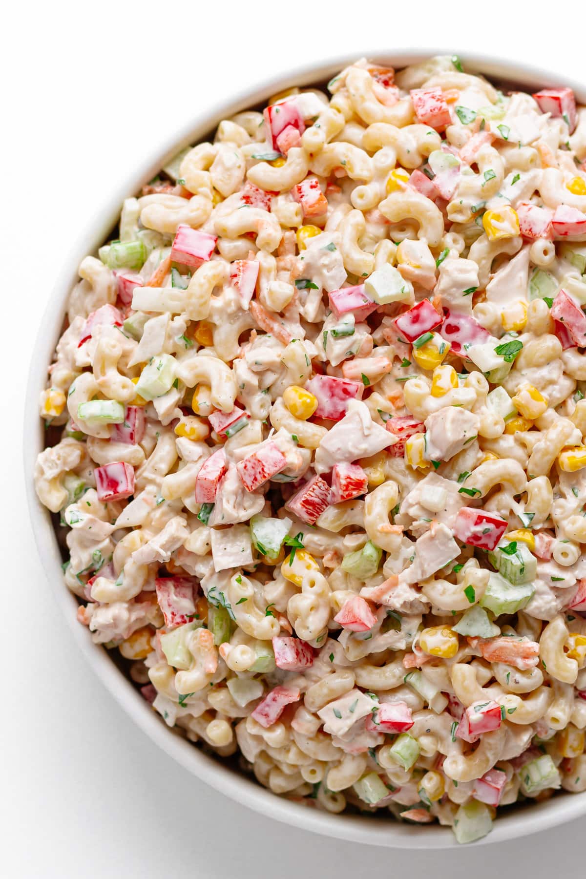 Macaroni salad with creamy dressing and chunks of chicken meat.