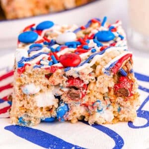 close up of a red, white and blue rice krispie treat on a swirled napkin