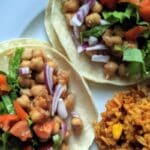 Tacos made with BBQ chickpeas, cheese and lettuce.