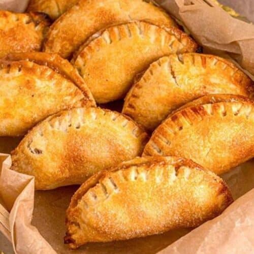 A tray of empanadas with caramel apple filling.