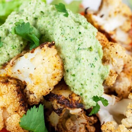 Chunks of chicken taco with cilantro cashew sauce over the top.