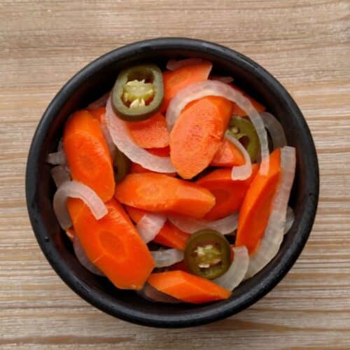 a bowl of pickled carrots and peppers.