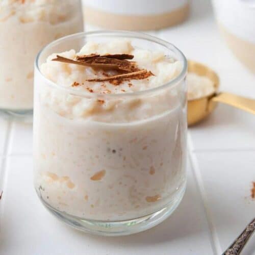 A dish of rice pudding with cinnamon over the top.