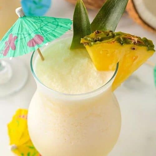 Frozen pina colada drinks with umbrellas inside.