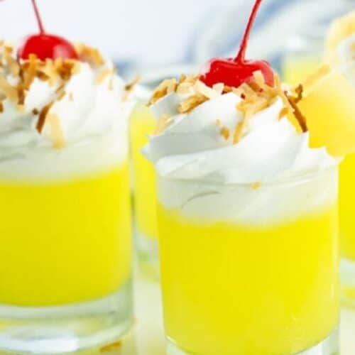 Pineapple jello shots with coconut cream topping.