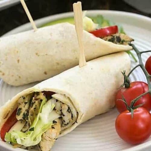 Soft chicken tacos with wooden skewers through the middle.