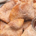 Sopapillas on a plate with cinnamon sugar coating.