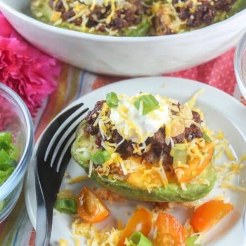 avocado halves stuffed with taco fillings like meat and cheese.