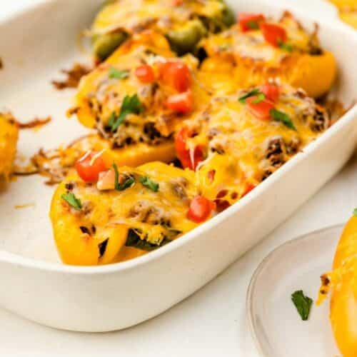 Stuffed peppers with taco meat and toppings.