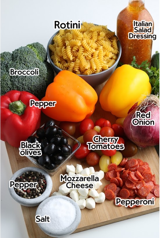 Ingredients to make zesty Italian pasta salad with labels.