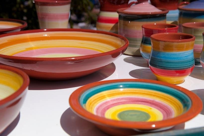 Multi-colored dishes on a white counter top.