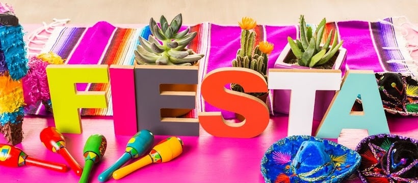 Fiesta sign surrounded by taco party decorations.