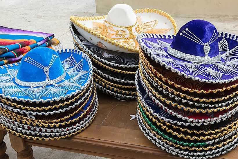 Stacks of colorful sombreros on a table.