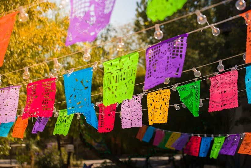 Multi-colored flags on banners for taco party.