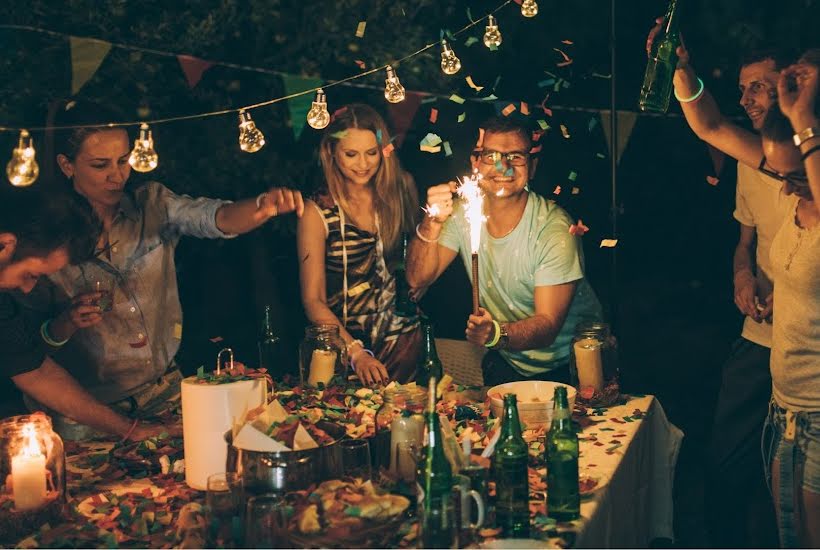 Guest gathered around a fiesta table for a taco party.