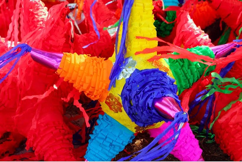 Colorful pinatas for taco party decorations.