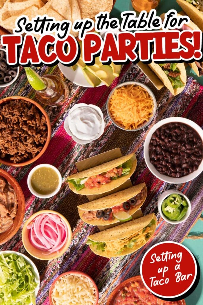 Table filled with tacos, fillings and toppings with Setting Up a Taco Bar text overlay.