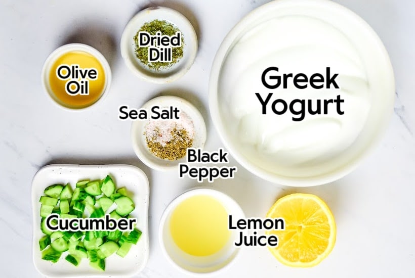 Ingredients to make homemade tzatziki sauce with labels.