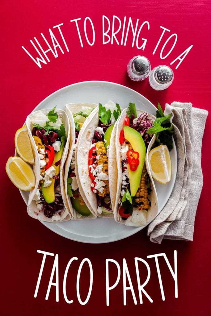 White plate filled with tacos garnished with slices of avocado and lemon wedges with What to Bring to a Taco Party text overlay.