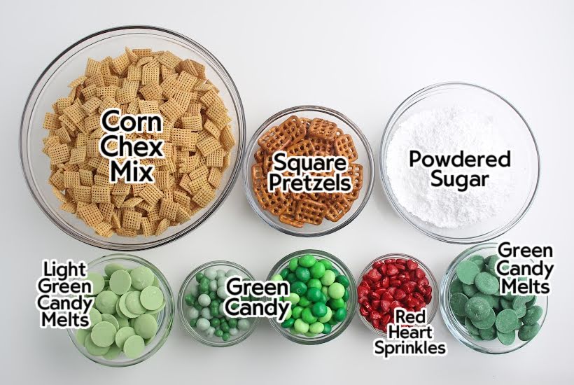 Bowls of ingredients to make Grinch-themed Chex mix with text labels.