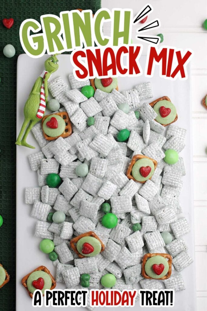 Grinch snack mix with pretzel bites and candies on a white board with text overlay.